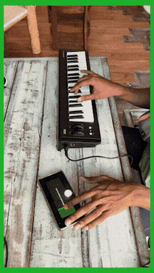 Hands playing a keyboard and a phone interface
