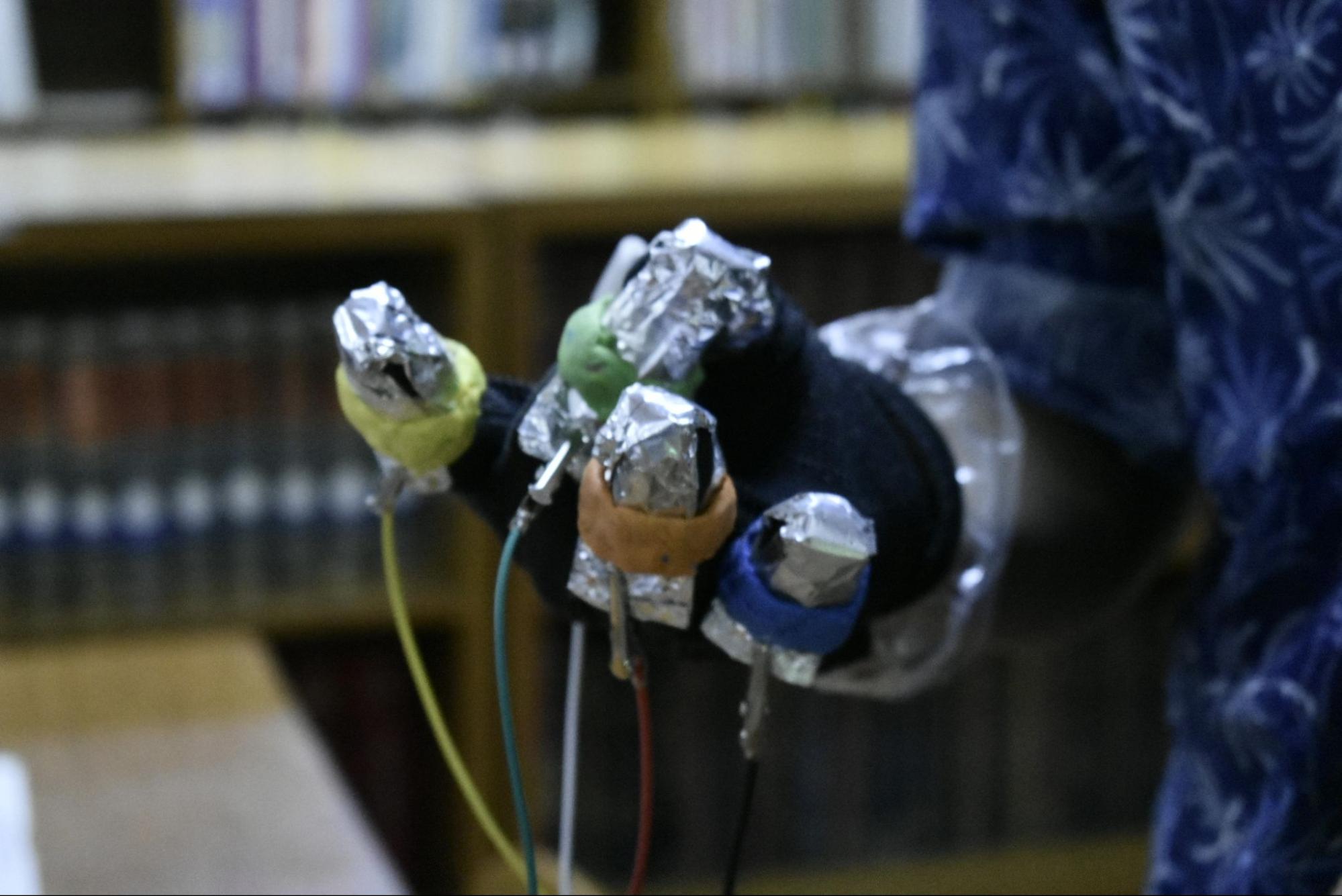 Close-up of a sensor glove connected with jumper wires